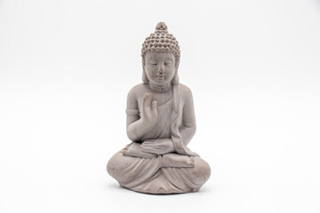 Obraz premium Serene Stone Buddha Statue in a Meditative Pose Against a Minimalist White Background