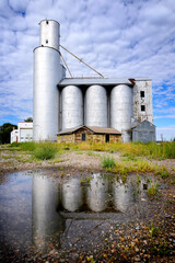 Old Abandoned Granary Grain Silo in Rural Area Blue Sky and Dramatic Clouds