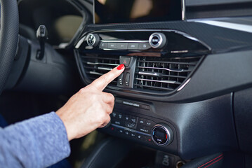 Fototapeta premium Activating the hazard warning light in a passenger car