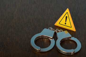 Caution and Control: Handcuffs and Warning Sign Symbolizing Security and Alertness