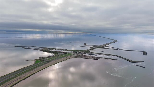 Aerial of sea wall, dike, afsluitdijk with locks in IJsselmeer lake