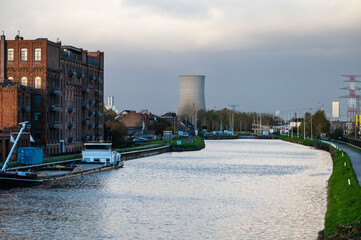 Fototapeta premium Boat and autumn landscape reflecting in the canal, bridge view in Lot, Beersel, Flemish Brabant, Belgium