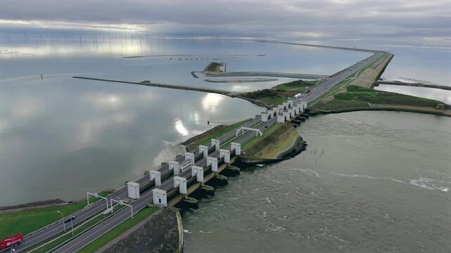 Aerial of sea dike with lock and sluice complex and A7 highway at Afsluitdijk