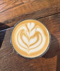 Creamy Latte with Tulip Art on a Wooden Table