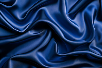 Fototapeta premium Shiny blue velvet, silk or chiffon fabric arranged in a embossed pattern reflecting light beautifully, suitable for use as a background or wallpaper. 