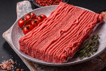 Raw ground beef or pork with salt, spices, herbs and tomatoes
