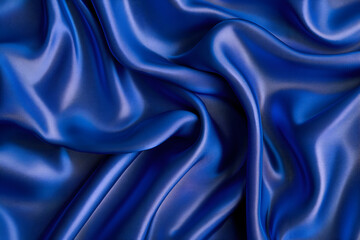 Obraz premium Shiny blue velvet, silk or chiffon fabric arranged in a embossed pattern reflecting light beautifully, suitable for use as a background or wallpaper.