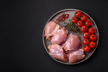 Fresh raw chicken thigh fillets with salt, spices and herbs