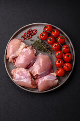 Fresh raw chicken thigh fillets with salt, spices and herbs