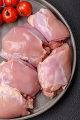 Fresh raw chicken thigh fillets with salt, spices and herbs