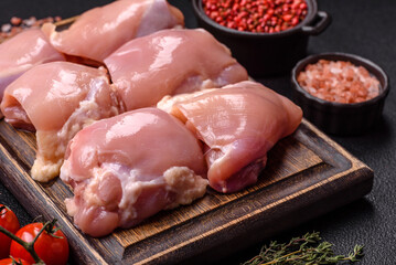 Fresh raw chicken thigh fillets with salt, spices and herbs