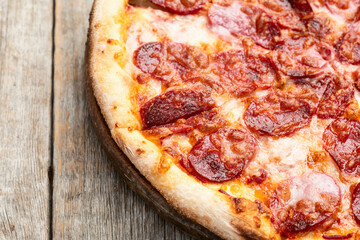 Pizza pepperoni fast food . Top view on rustic background
