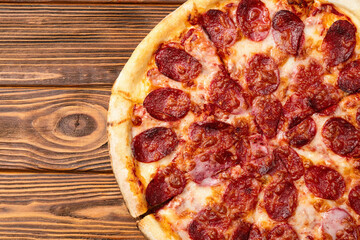 Pizza pepperoni fast food . Top view on rustic background