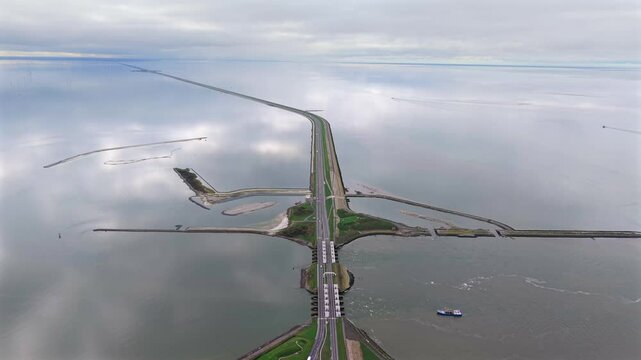 Aerial of sea wall, dike, afsluitdijk with locks in IJsselmeer lake 