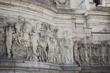 A close-up of the detailed marble reliefs adorning the Victor Emmanuel II Monument in Rome.