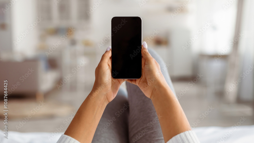 Poster point of view of black woman holding cellphone with blank empty screen for mock up in hands, young l