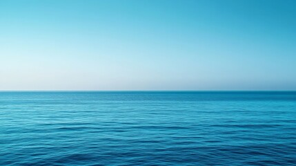 Fototapeta premium Tranquil Ocean Horizon: A Serene Blue Sky Meets the Calm Sea