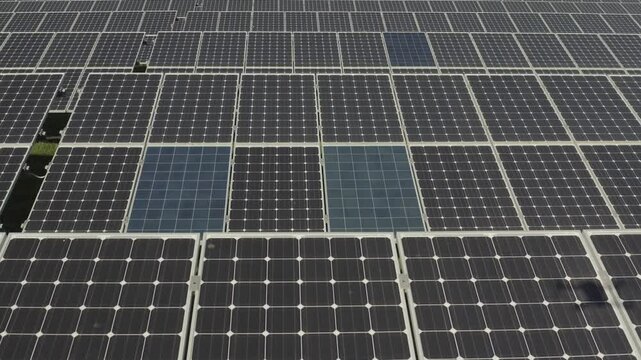 aerial 4k drone view of photovoltaic solar panel energy technology field