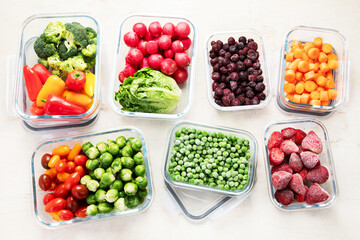 Boxes with fresh raw vegetables on table.