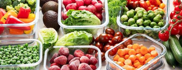 Boxes with fresh raw vegetables on table.