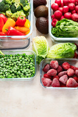 Boxes with fresh raw vegetables on table.