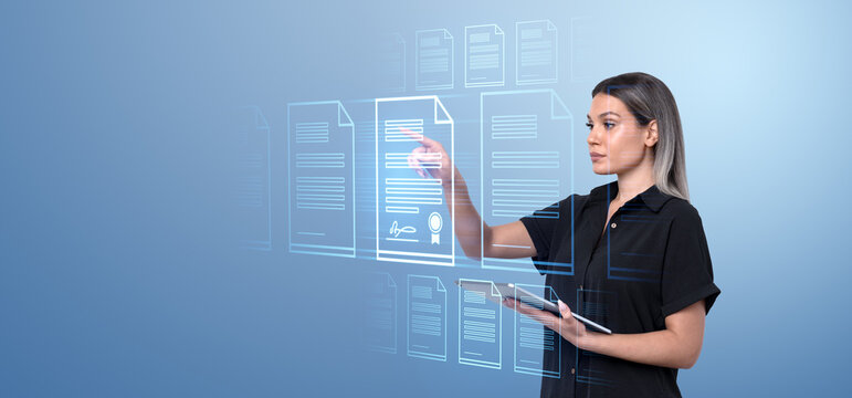 Woman interacting with virtual holographic documents on a blue d