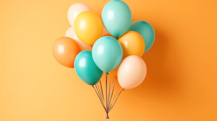 Colorful group of helium balloons against a vibrant orange background, featuring shades of teal, yellow, and orange