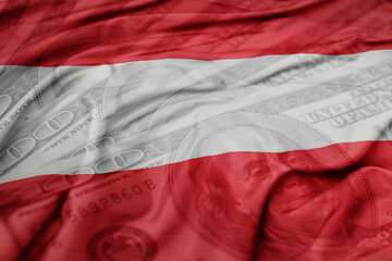 waving colorful flag of austria on the dollar money background. finance concept.