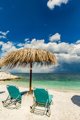 Empty lounge chairs on the beach. Marble pebbles beach, Thasos island, Northern Greece, EU, Europe