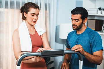 Obraz premium Athletic body and sporty young couple or workout buddy in sportswear warmup or resting after finishing in home workout exercise at gaiety home exercise and healthy lifestyle concept.