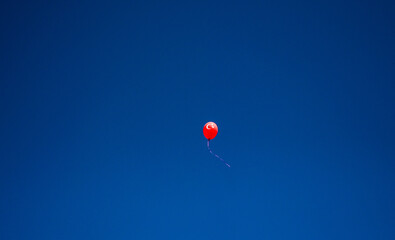 A balloon in the air with the flag of the Republic of Turkey painted on it. Red balloon with white crescent and star. Turkish flag. 