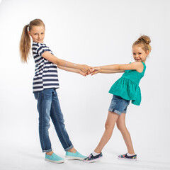 Two beautiful girls sisters, isolated on white background