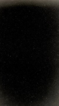 Retro black and white abstract filmstrip background. Empty loop old movie texture. Looping analog film. Reel scratches, dirty, noise moving. Vintage monochrome film. Retro 1960s 8mm archive. Old Movie