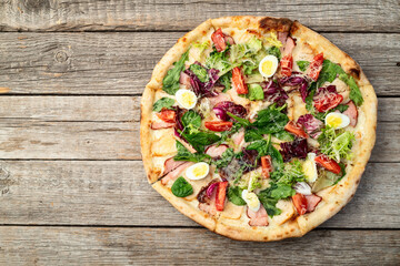 Italian pizza caesar with eggs salad chicken tomatoes and mozzarella photography. top view