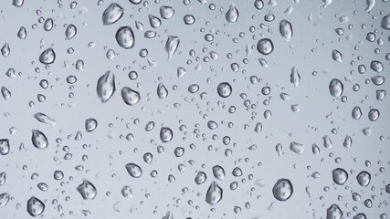 Rain Drops Sliding Down a Window. Mesmerizing Close-Up of Rain Drops Rolling Down a Glass Pane During a Gentle Rainfall - Powered by Adobe