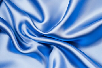 Luxurious blue silk fabric with smooth flowing folds and soft highlights showcasing rich texture and elegance