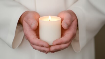 Caucasian male adult holding lit candle in both hands