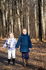 Fototapeta premium Two sisters in autumn park