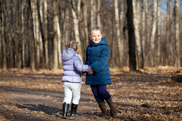 Fototapeta premium Two sisters in autumn park