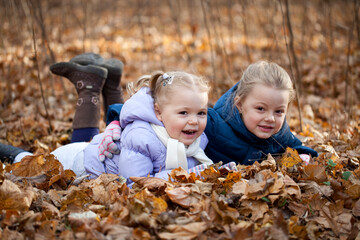 Two sisters in autumn park