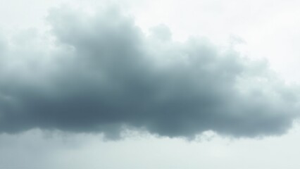 A close-up of a dark, heavy storm cloud against a pale, overcast sky. Captures the dramatic and moody essence of impending rain. Ideal for weather, nature, and atmospheric themes in creative projects.