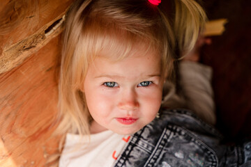 Portrait of a Caucasian child girl toddler outside in summer.