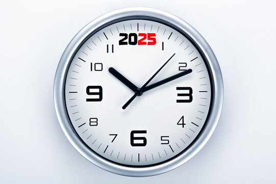 white clock face with black digits on a gray background closeup