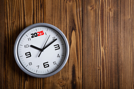 large white clock face with digits on a wooden background top view