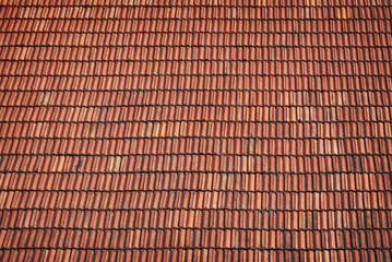 Old brown ceramic roof tiles, background.