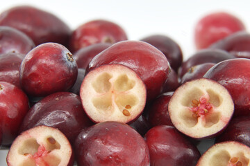 Close-Up of Fresh Red Cranberries with Halved Pieces