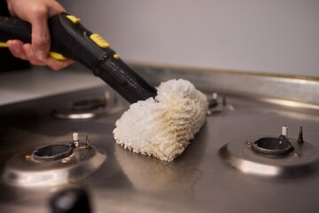 Performing a Deep Cleaning of Kitchen Equipment Using a Steam Cleaner for Hygiene and Safety