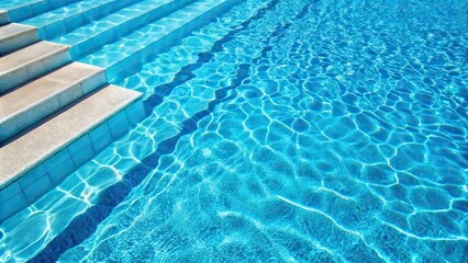 Obraz premium Close-up of a pool with blue water and white steps
