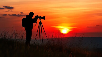 Silhouette of a photographer capturing the sunset with a camera on a tripod.