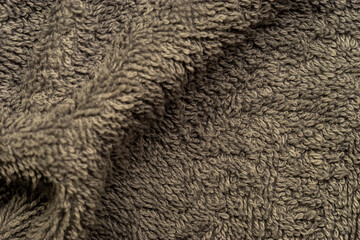 Soft brown towel fabric showing its fluffy texture.